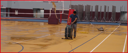 Man Cleaning the Gym Floor